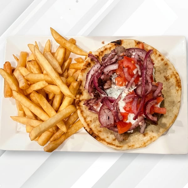 Gyro with sliced red onions, diced tomatoes, and white sauce, served with golden french fries.